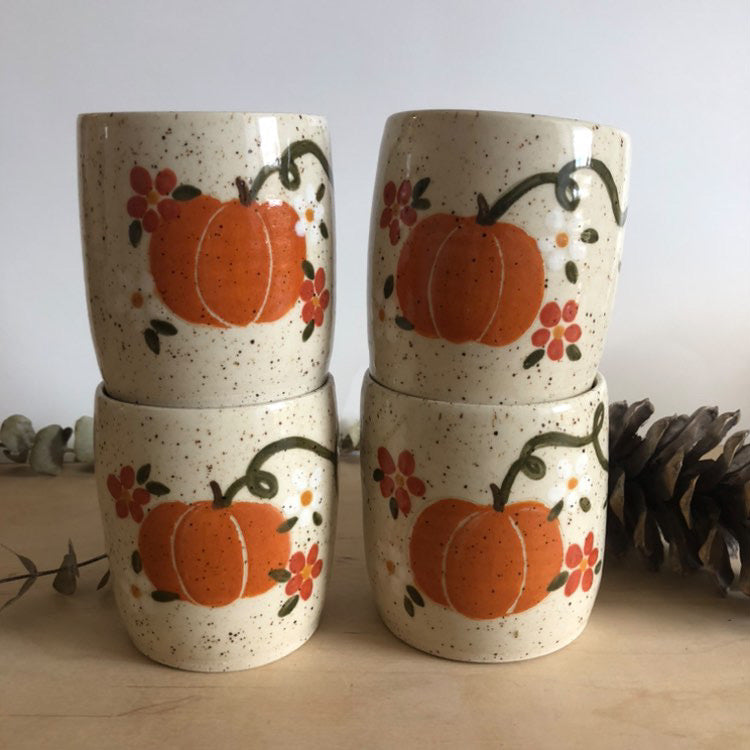 Handmade pottery mugs with pumpkin decor