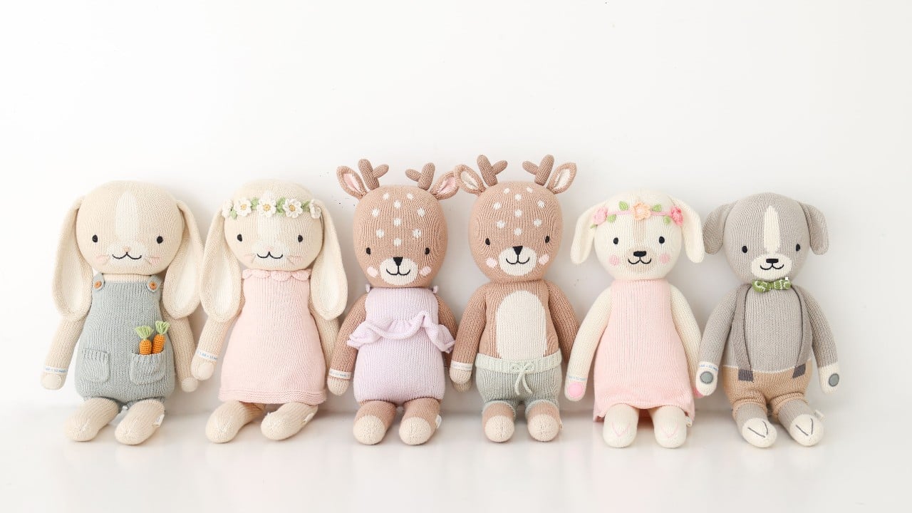 A collection of handknit Cuddle and Kind dolls