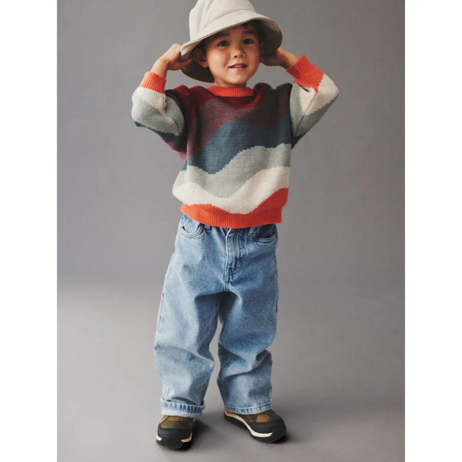 Little boy in sweater, jeans and a bucket hat