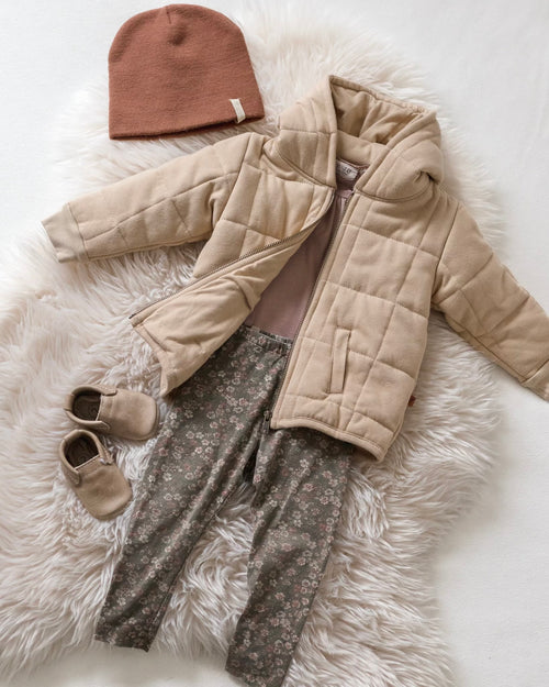 Preloved outfit with grey floral pants and a beige coat