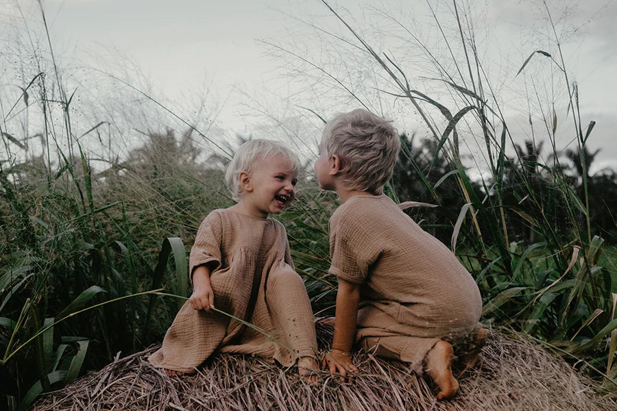 Two children modelling The Simple Folk collection from Thistle & Wren Boutique.