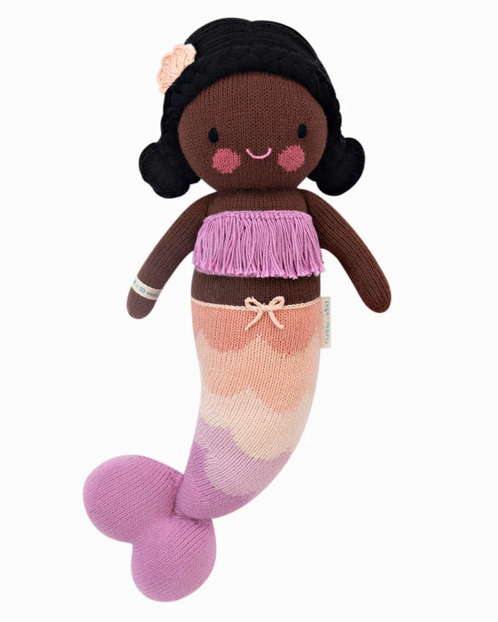 Maya knitted mermaid doll with black yarn hair, a lilac fringed top and a pink scalloped tail.